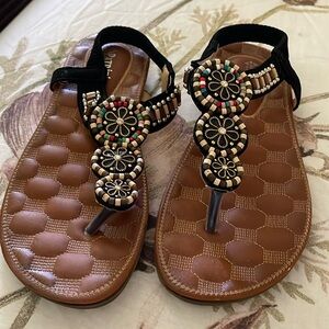 These sandals have beautiful design in the front with multicolored accents.